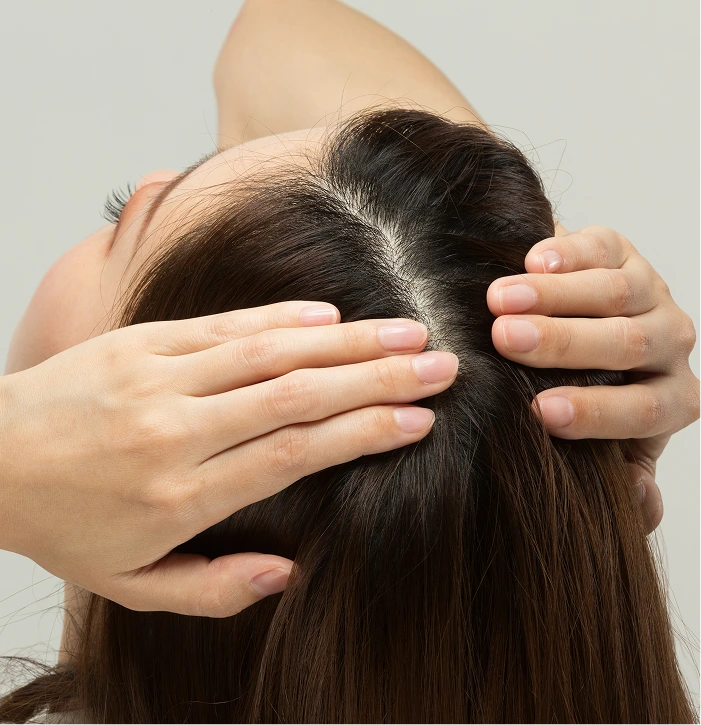 Therapist performing Korean scalp massage with hands on client's head