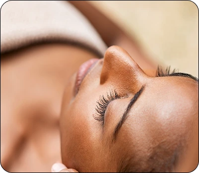 Close-up of client's face during facial treatment with eyes closed