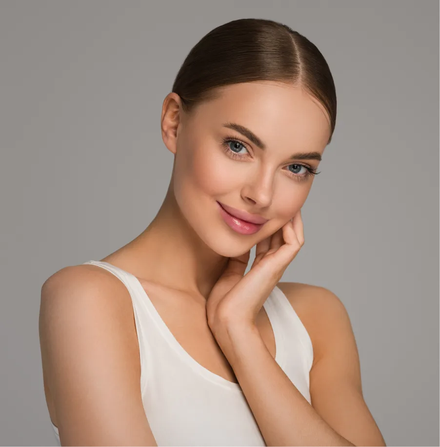 Woman with clear skin touching her face, demonstrating smooth complexion