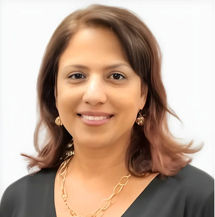 Woman with shoulder-length brown hair smiling at camera