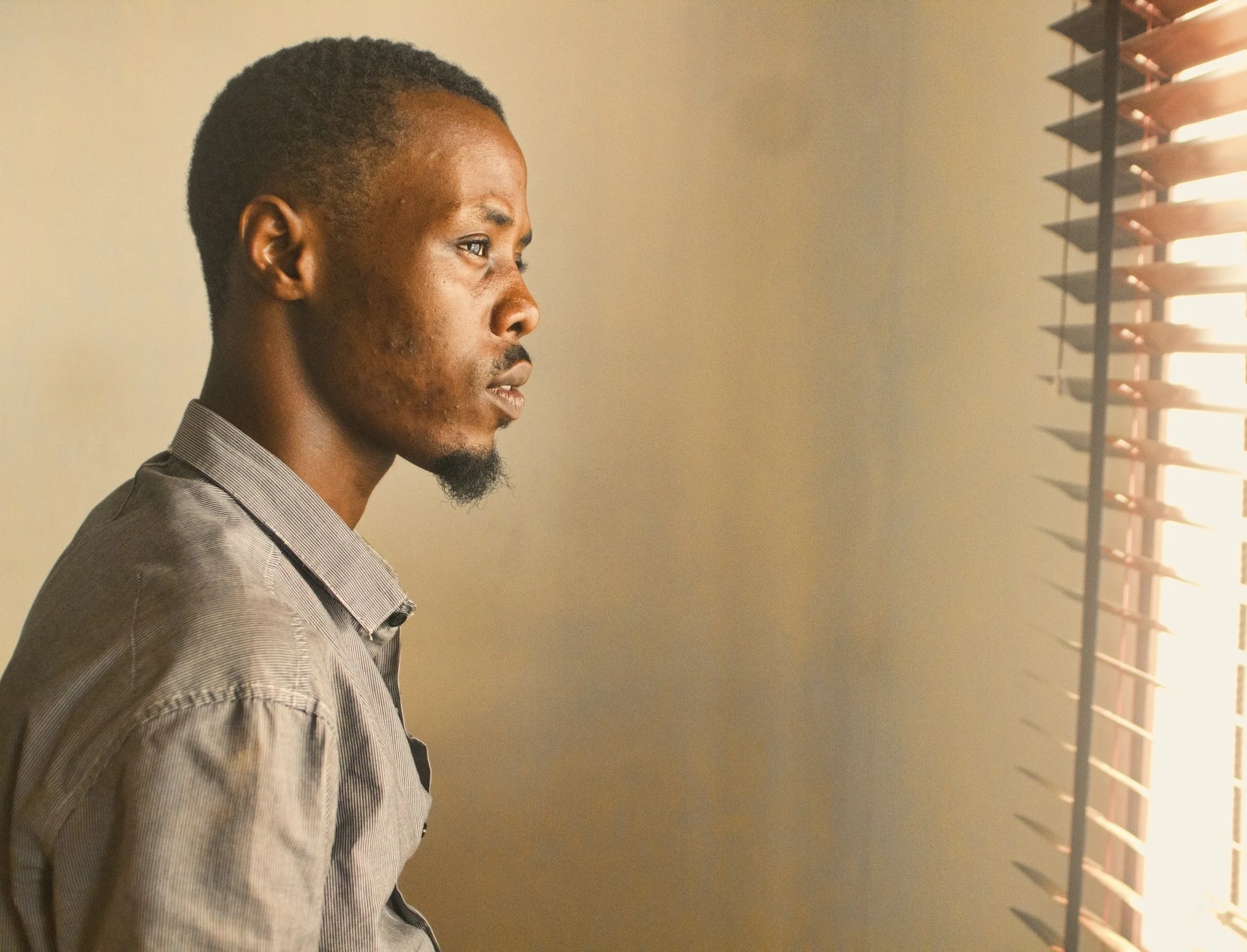 Man in quiet reflection by a window