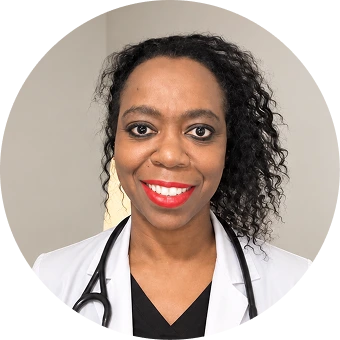 Nerisa Bryan, psychiatrist, wearing a white coat and stethoscope