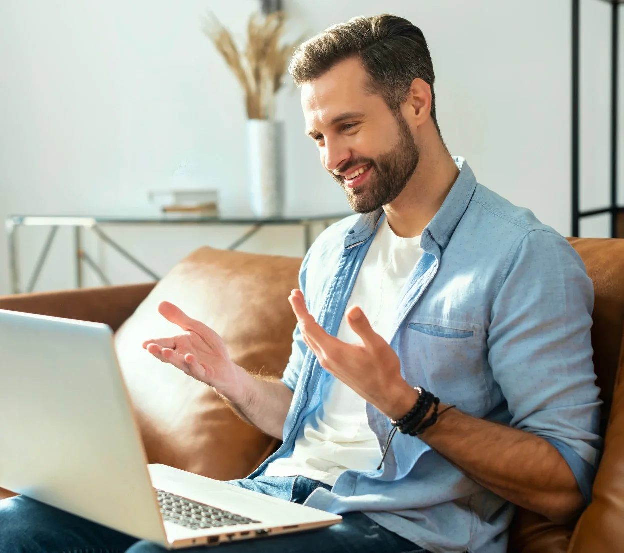 Man talking with his provider by video from his sofa