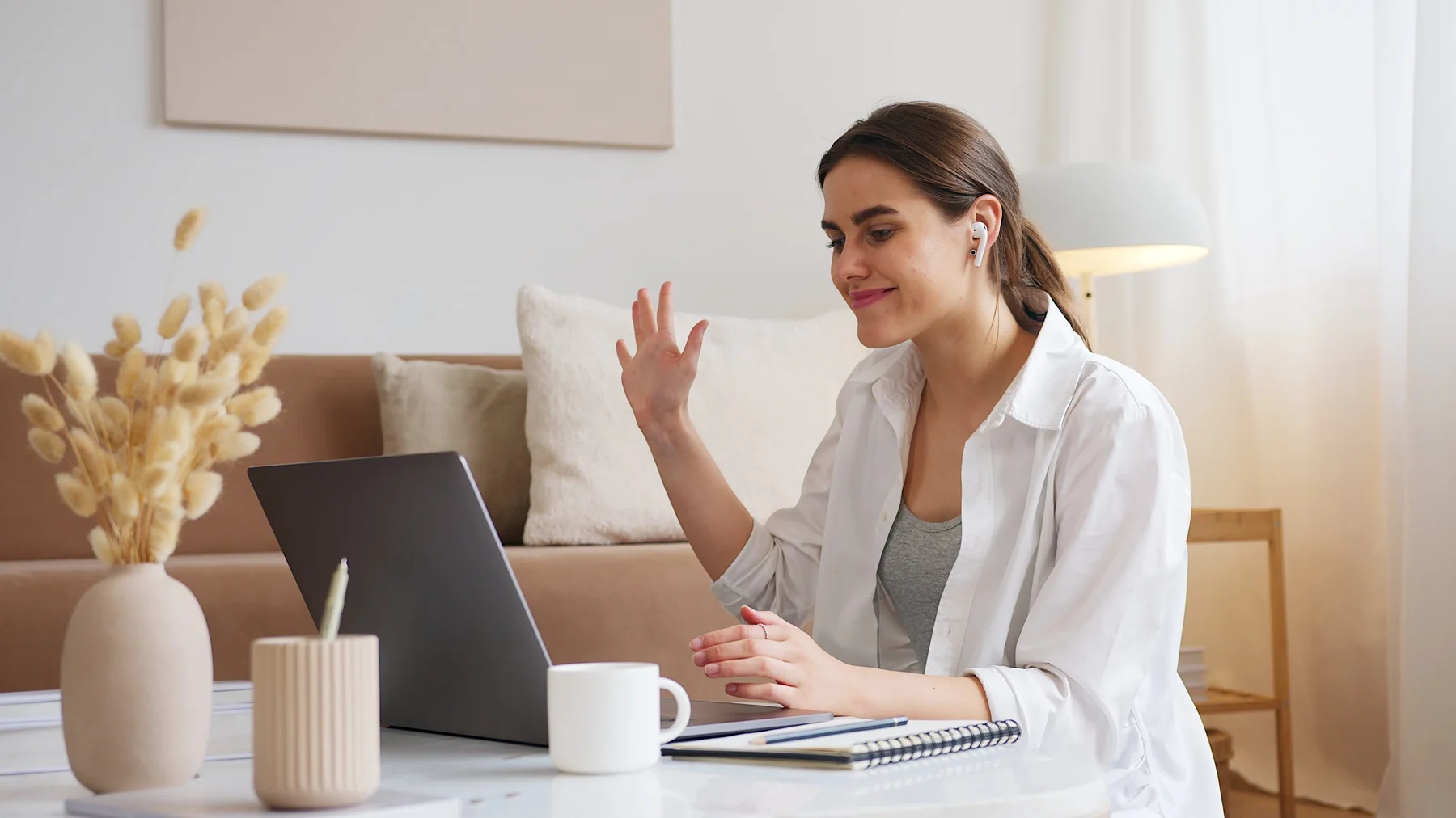 Woman speaking with her provider by video from her living room