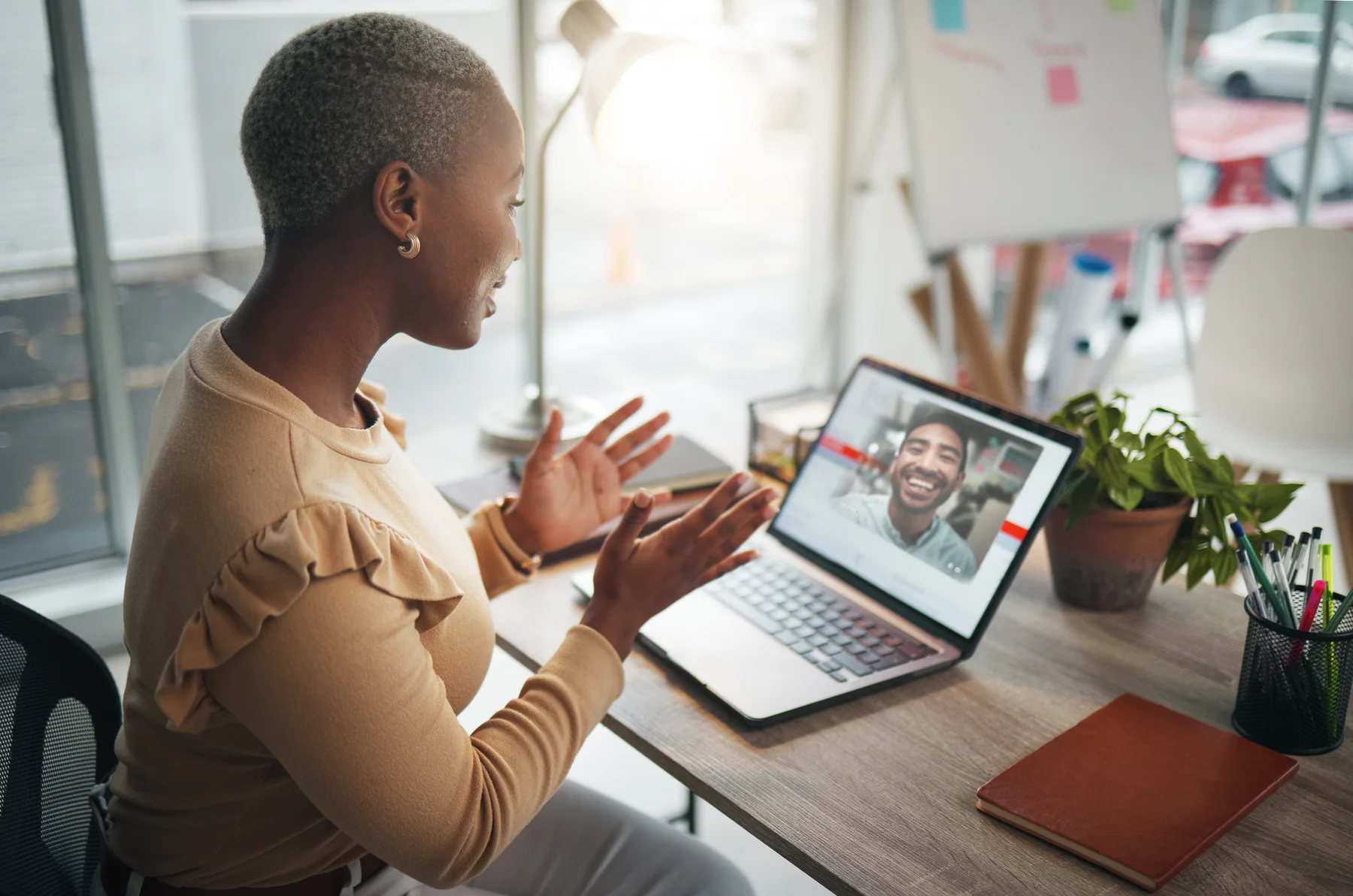 Woman talking with her provider during a virtual psychiatric visit on her laptop