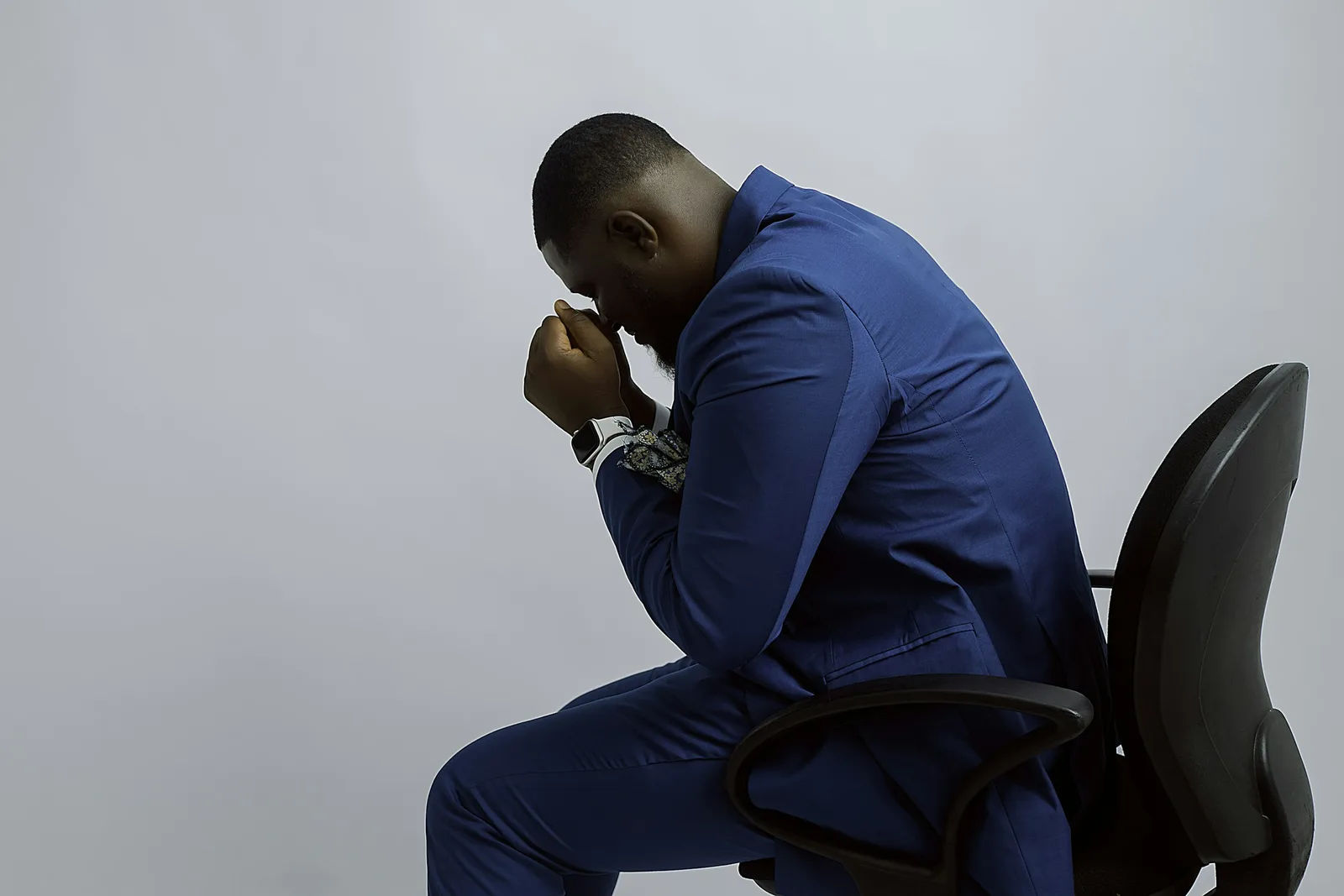 Man sitting with his head in his hand, feeling stressed
