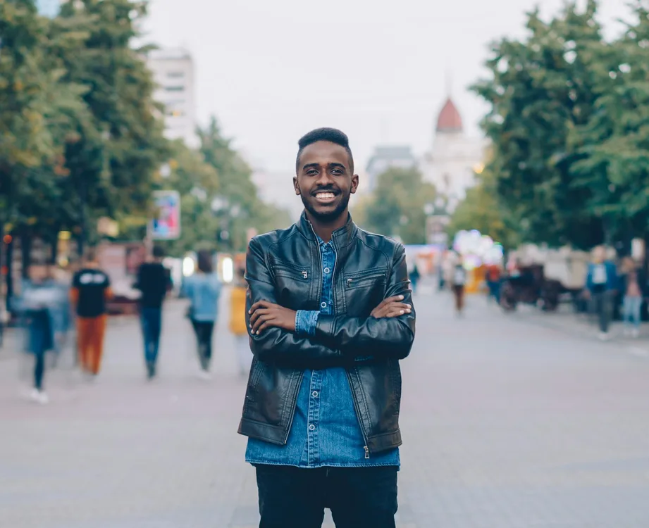 Man smiling on a city street