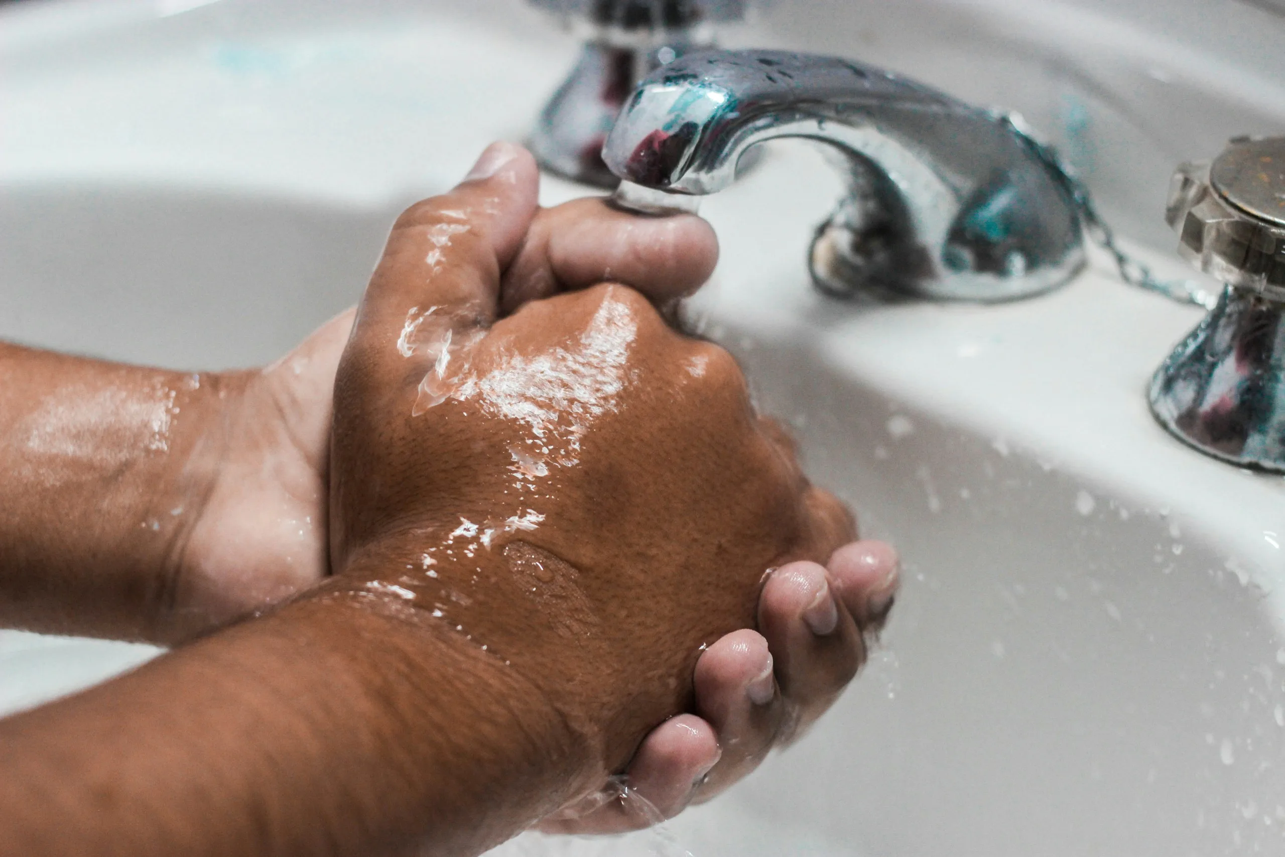 Person washing their hands at a sink