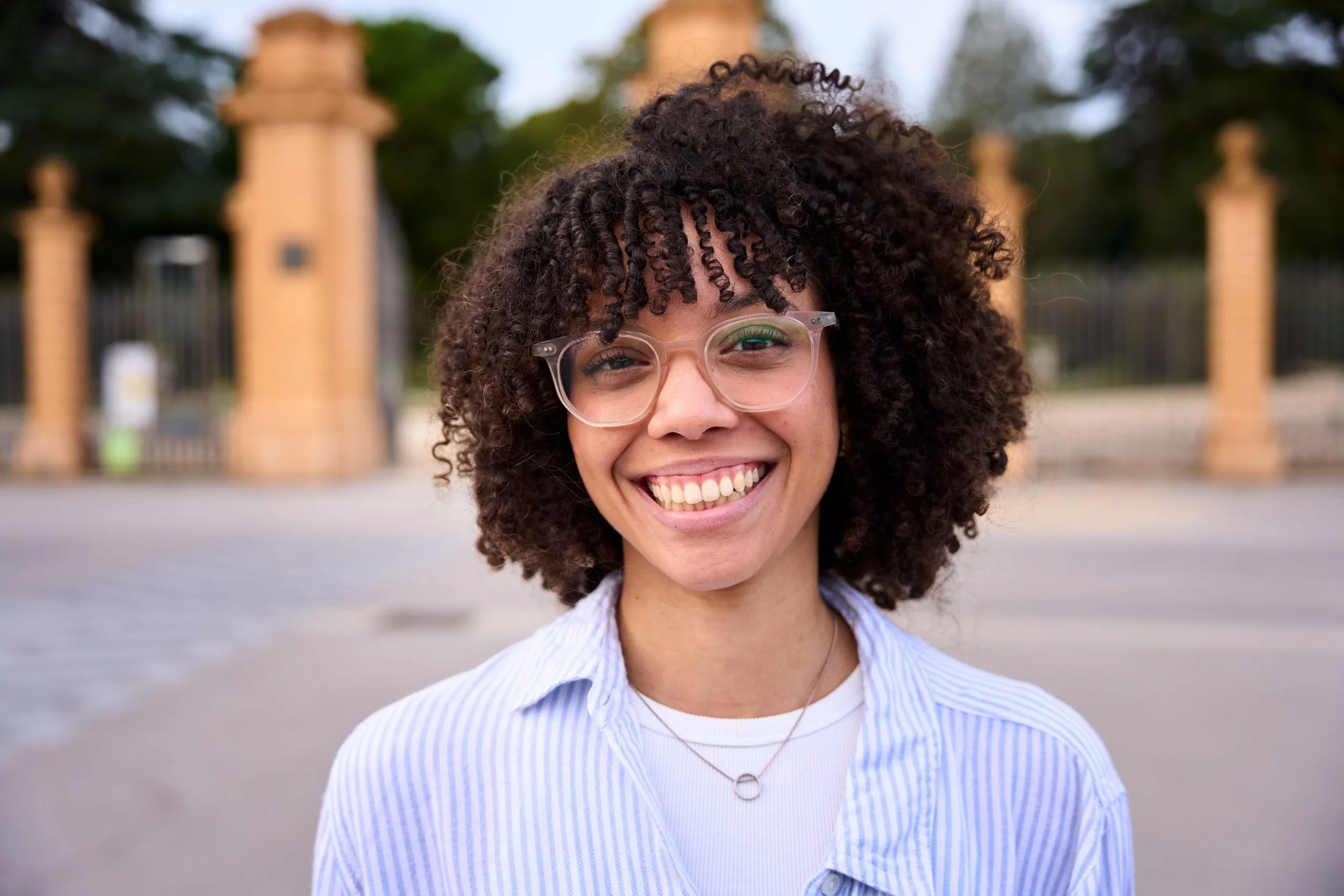 Smiling young woman in glasses, feeling restored after burnout treatment