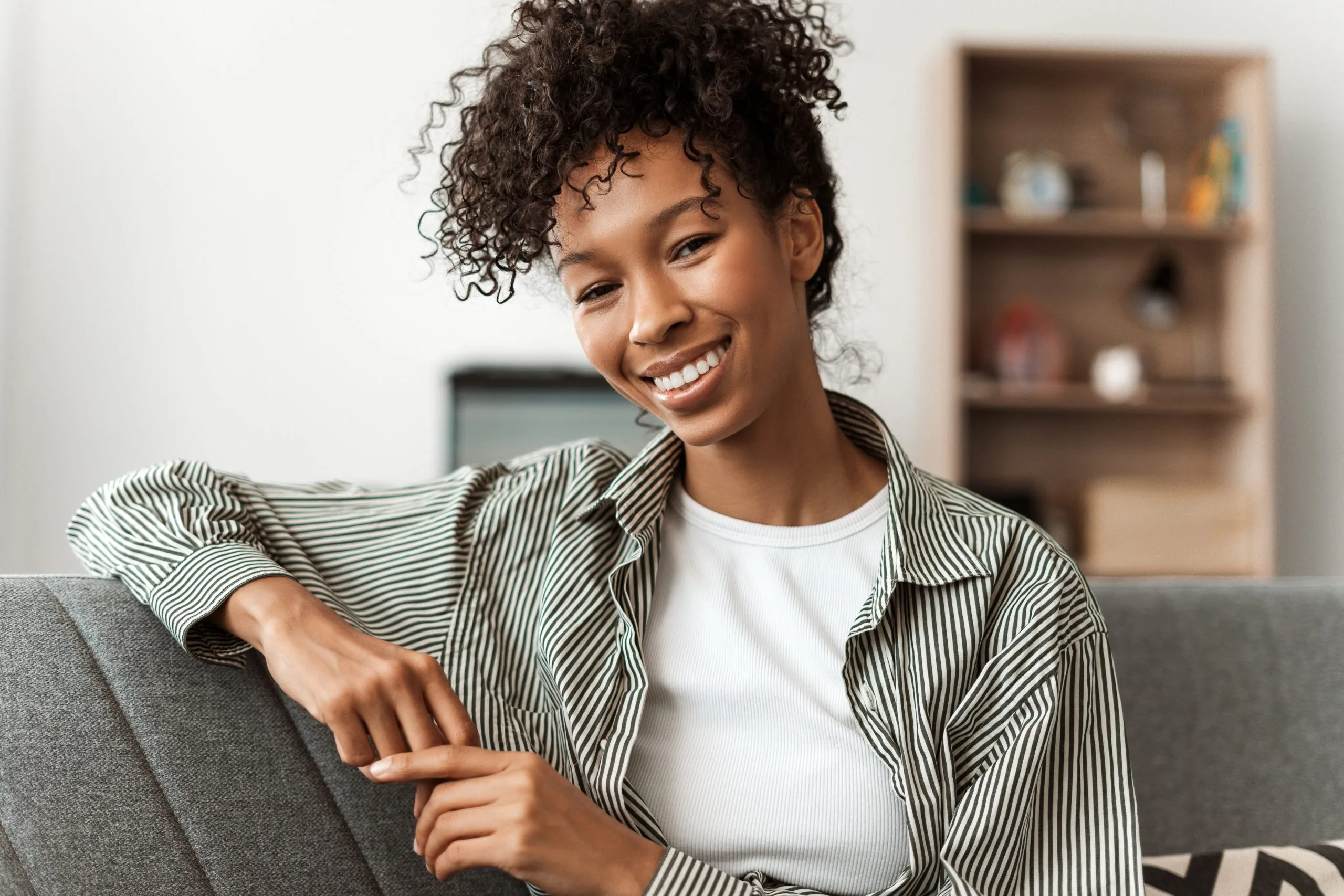 Relaxed smiling woman on a couch after stress management care