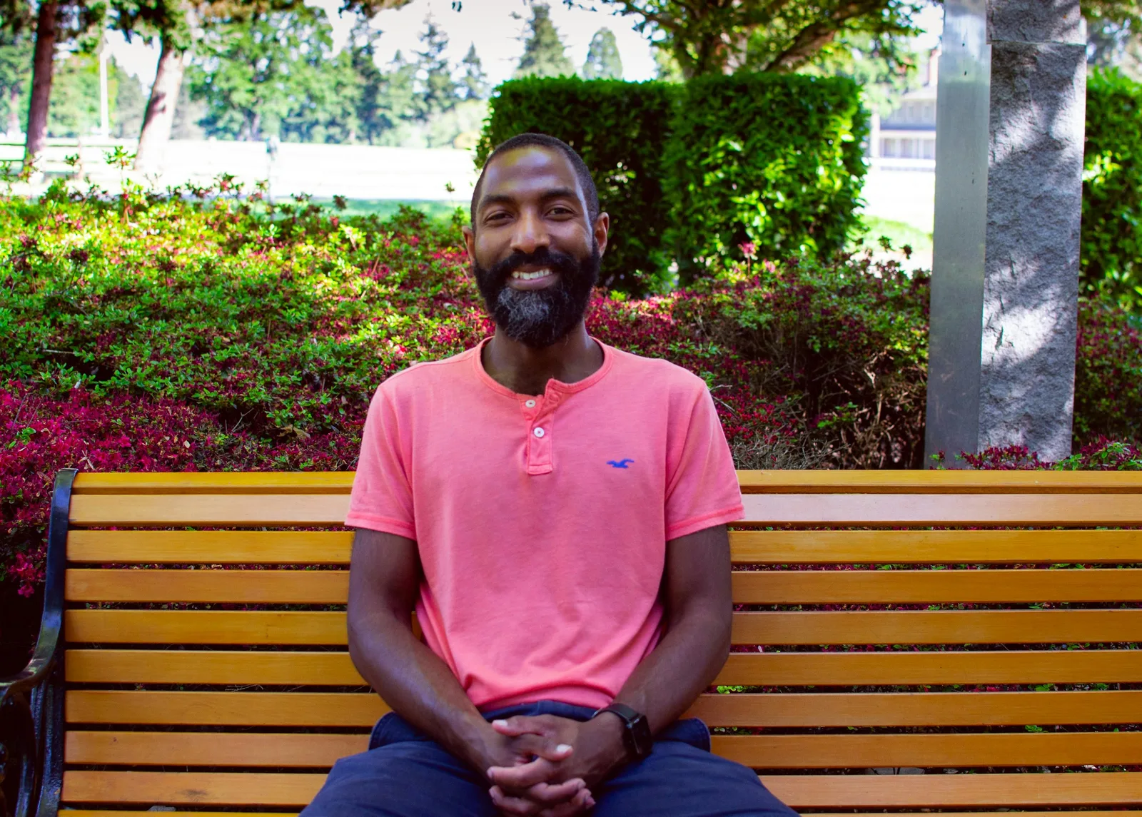 Man smiling on a park bench