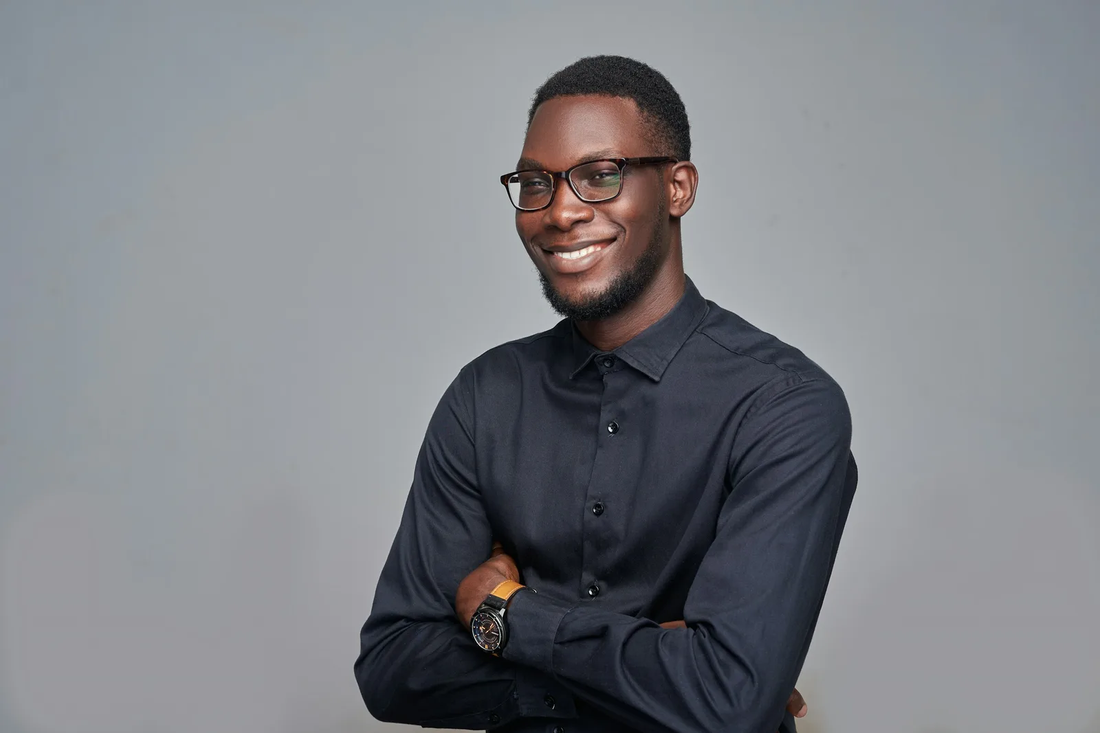 Man smiling with arms crossed