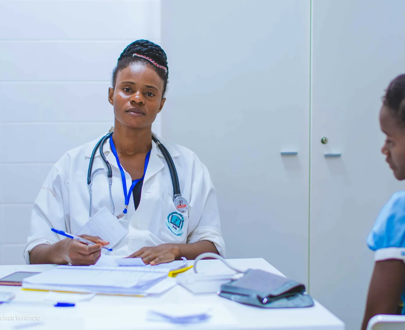 Provider meeting with a patient at her desk