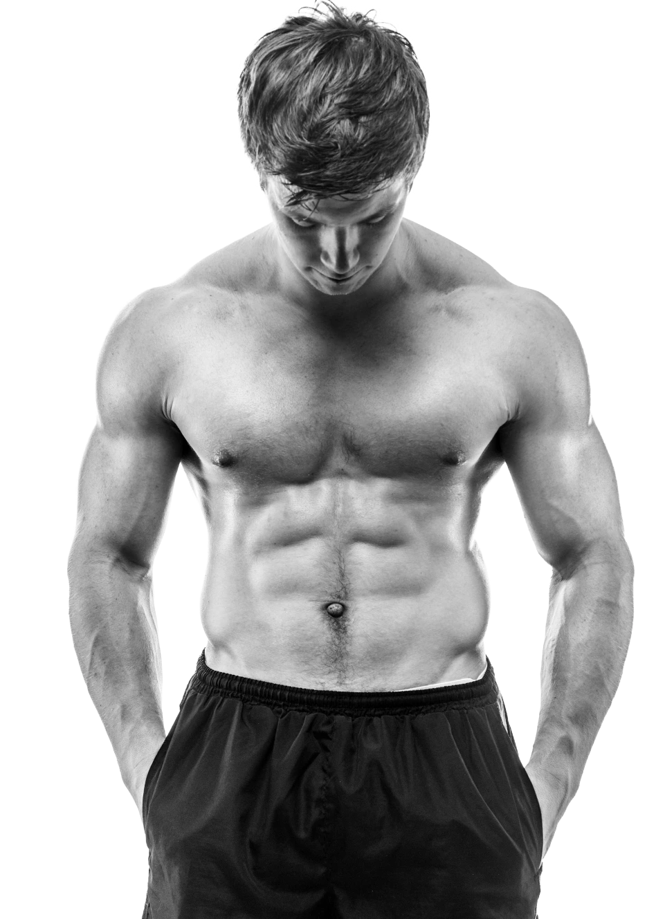 Shirtless muscular man looking down with defined abdominal muscles in black and white
