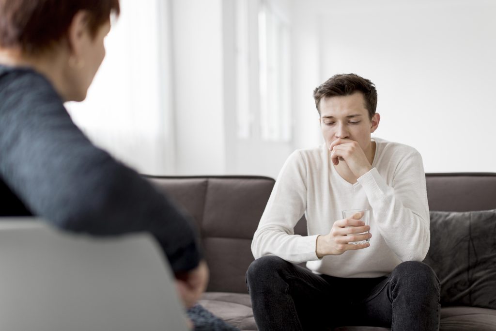 Patient and psychologist sitting on couch during therapy session