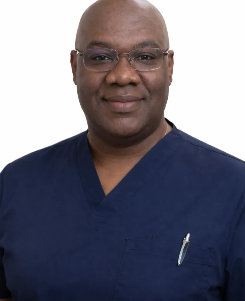 Jean Cetoute, healthcare provider wearing dark blue scrubs and glasses against white background