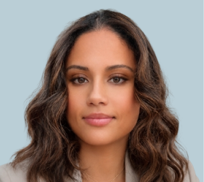 Woman with long brown wavy hair against light blue background