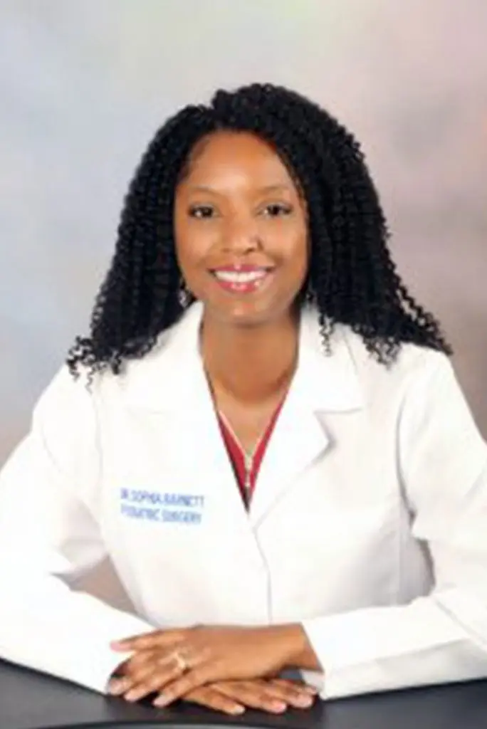 Female podiatrist in white coat with red stethoscope
