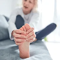 Podiatrist examining a patient's foot and ankle during clinical evaluation