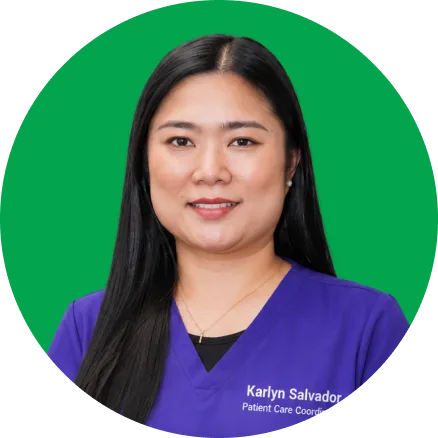 Karlyn Salvador, Patient Care Coordinator, wearing purple scrubs against green background