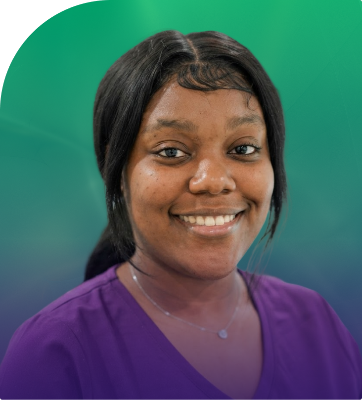 Asia Brewster smiling, wearing purple scrubs against teal background