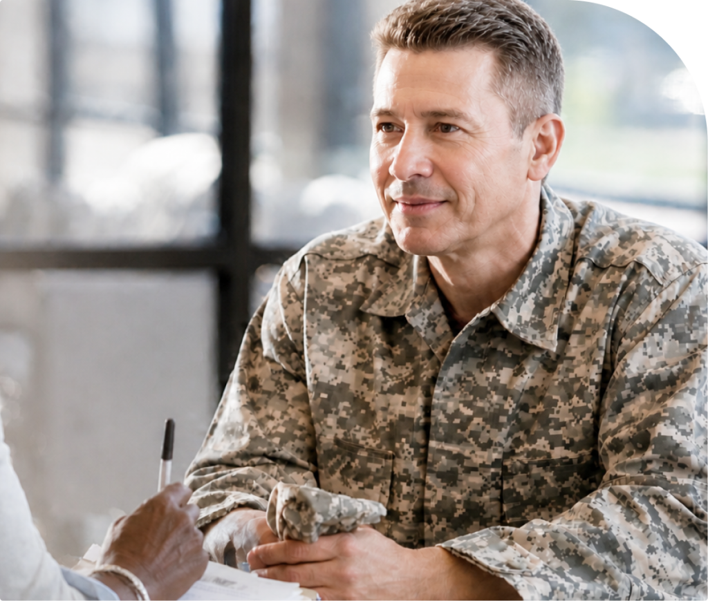 Military service member in camouflage uniform holding paperwork during a consultation