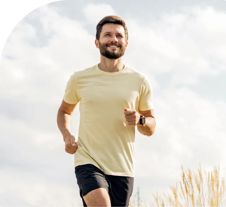 Man jogging outdoors in yellow shirt