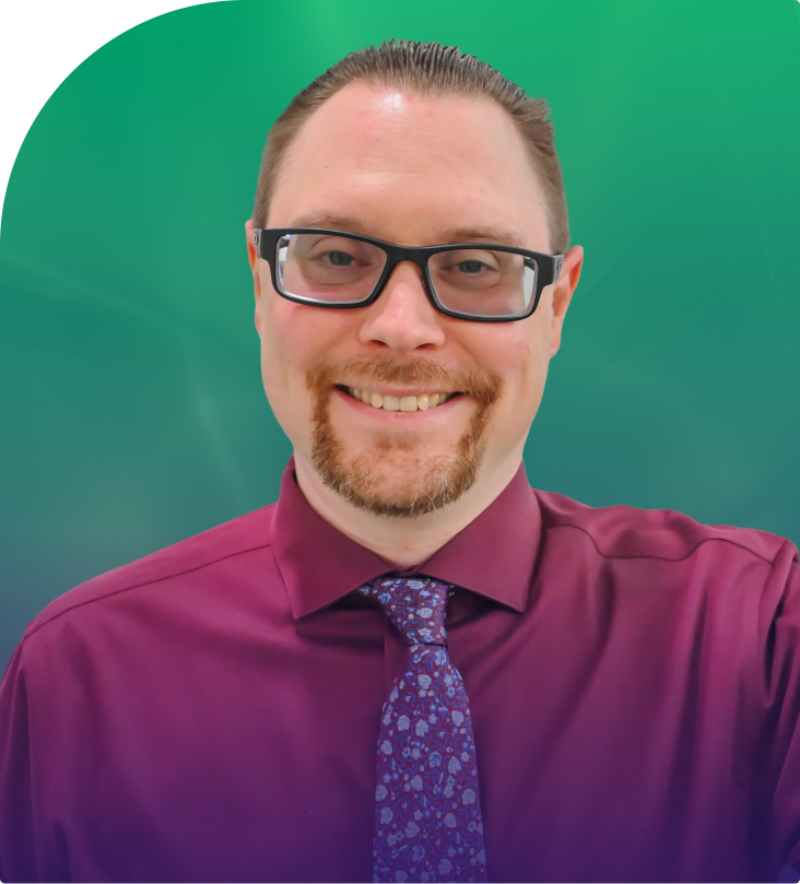 Thomas McKinnon, man with glasses wearing magenta shirt and patterned tie against teal background