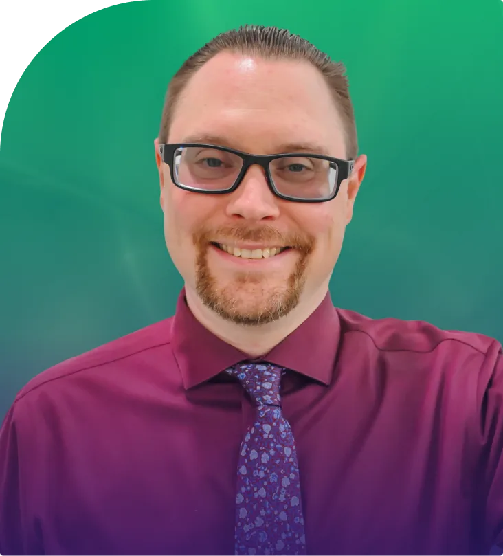 Thomas McKinnon, man with glasses wearing magenta shirt and patterned tie against teal background