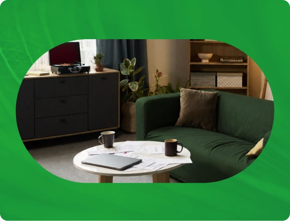 Comfortable consultation room with green seating, round white table, and warm lighting at Myndful Wellness