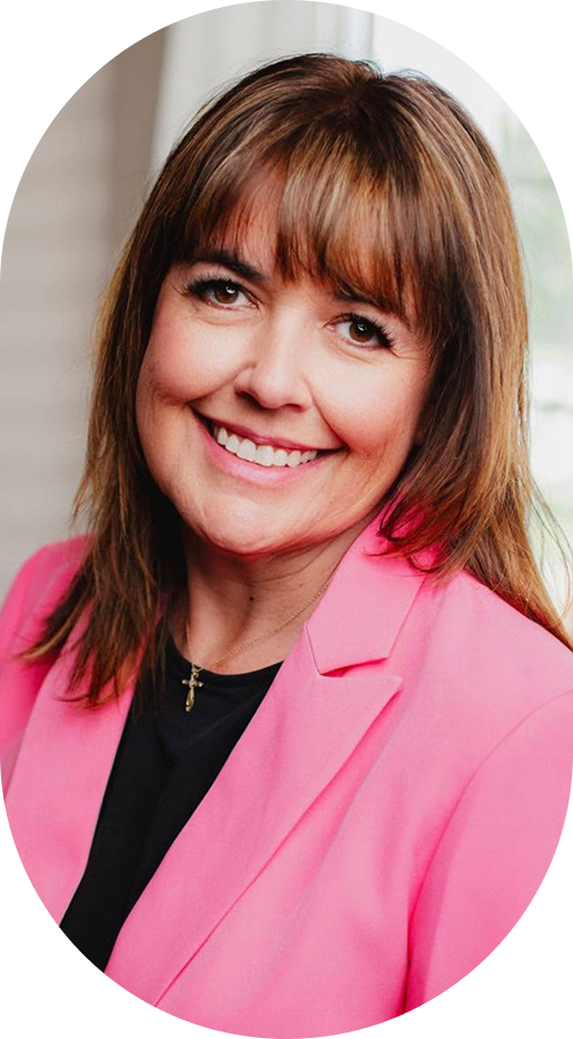 Woman wearing bright pink blazer smiling at camera