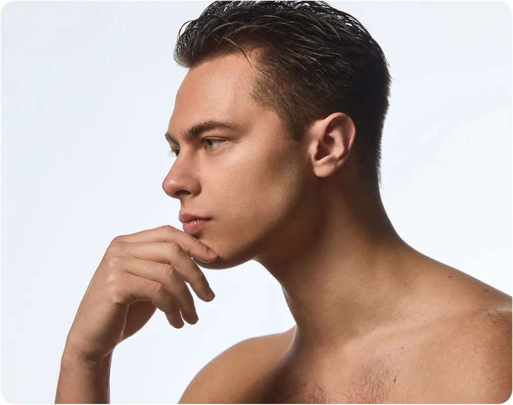 Man in profile with hand to face, demonstrating facial aesthetics