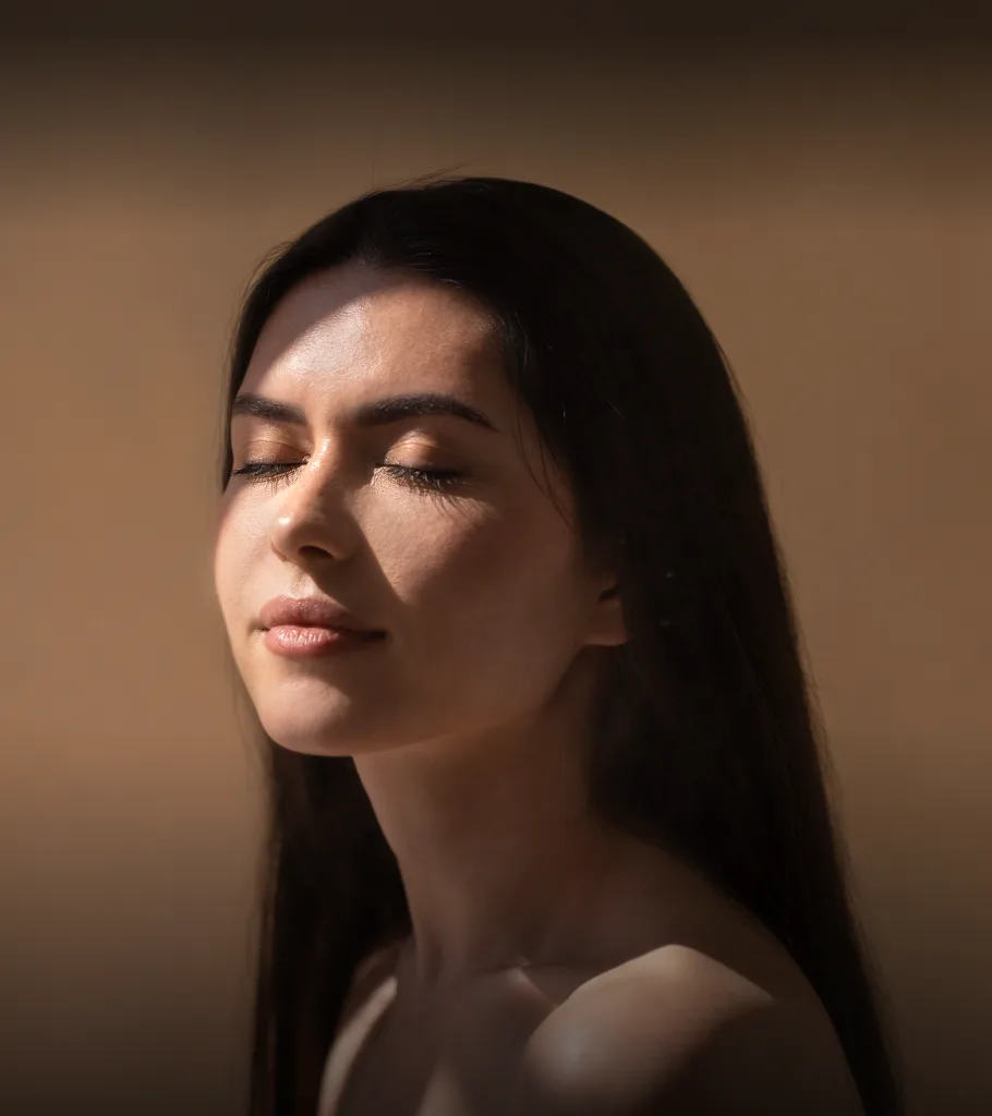 Woman's profile with closed eyes and glowing skin