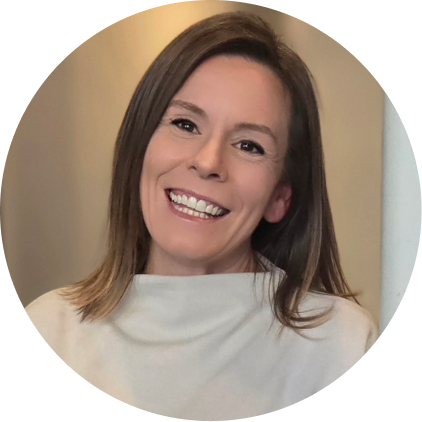 Woman with long brown hair wearing white turtleneck smiling at camera