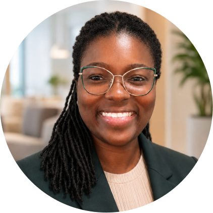 Woman wearing glasses and dark blazer smiling at camera in office setting