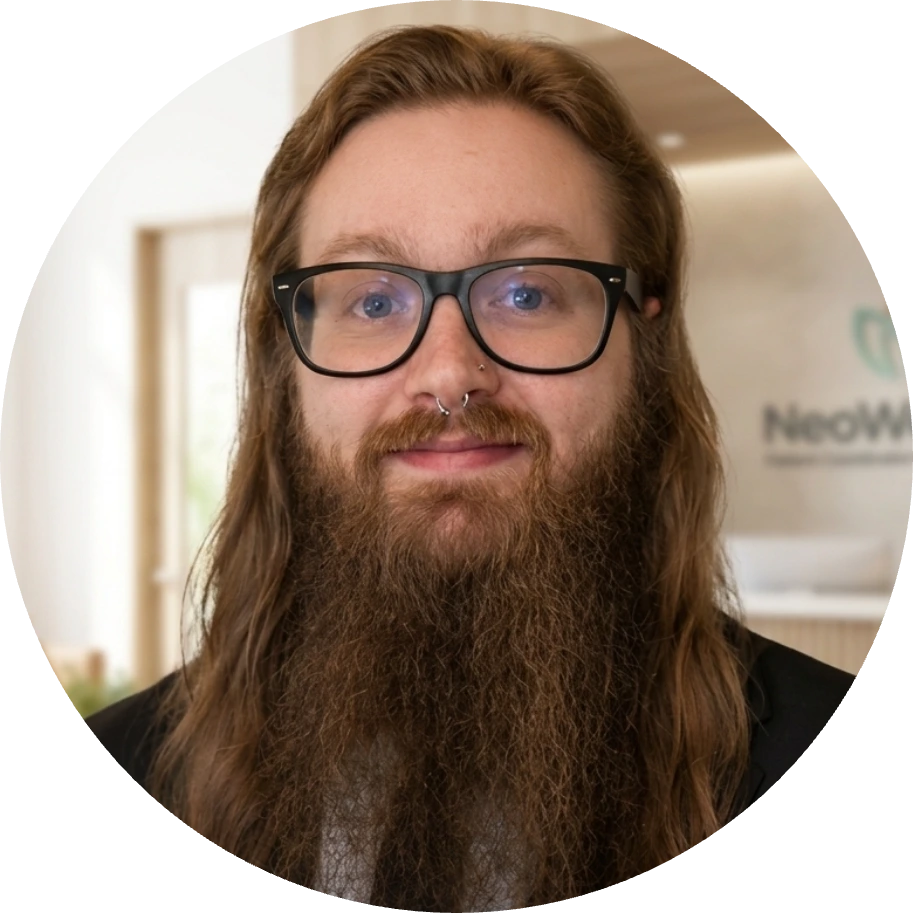 Christopher, Spravato Patient Coordinator and Intake Specialist, wearing glasses in a clinical office setting