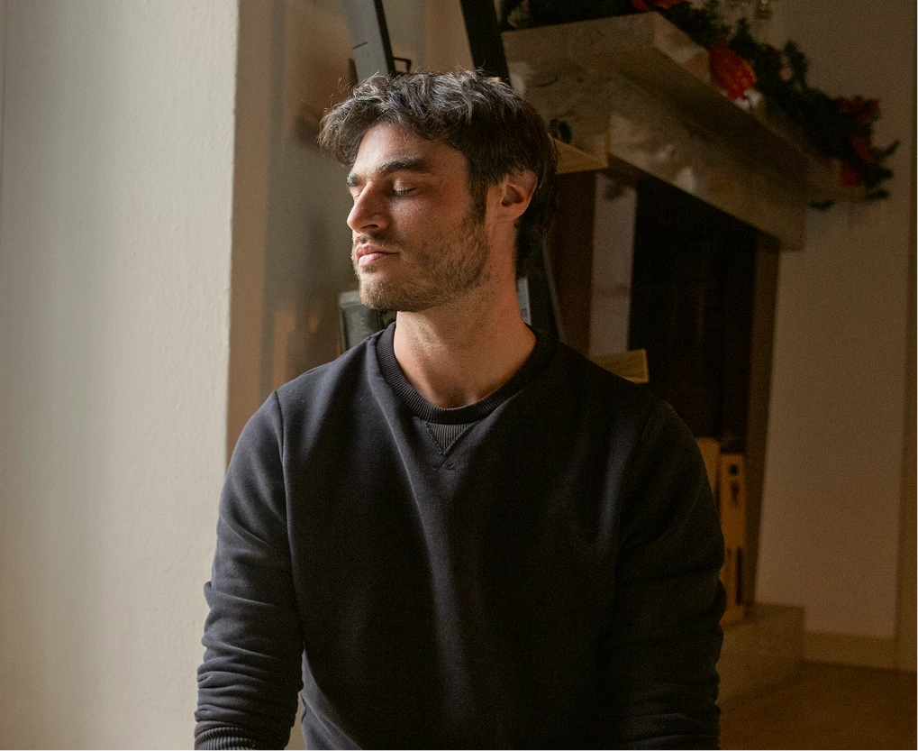 Man sitting by a window at home