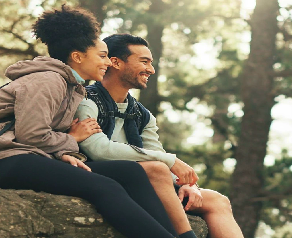 Couple smiling together on a forest hike