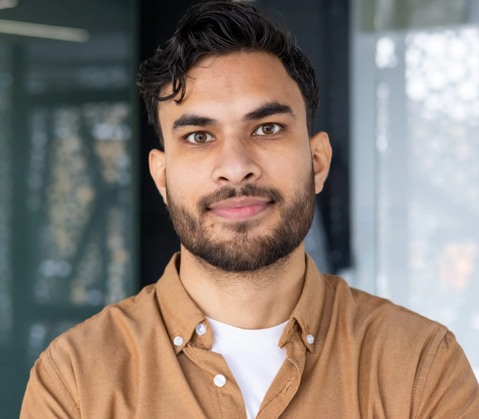 Smiling man in a tan shirt