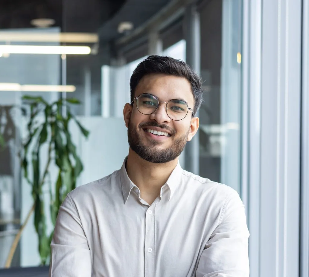 Smiling man with glasses in an office