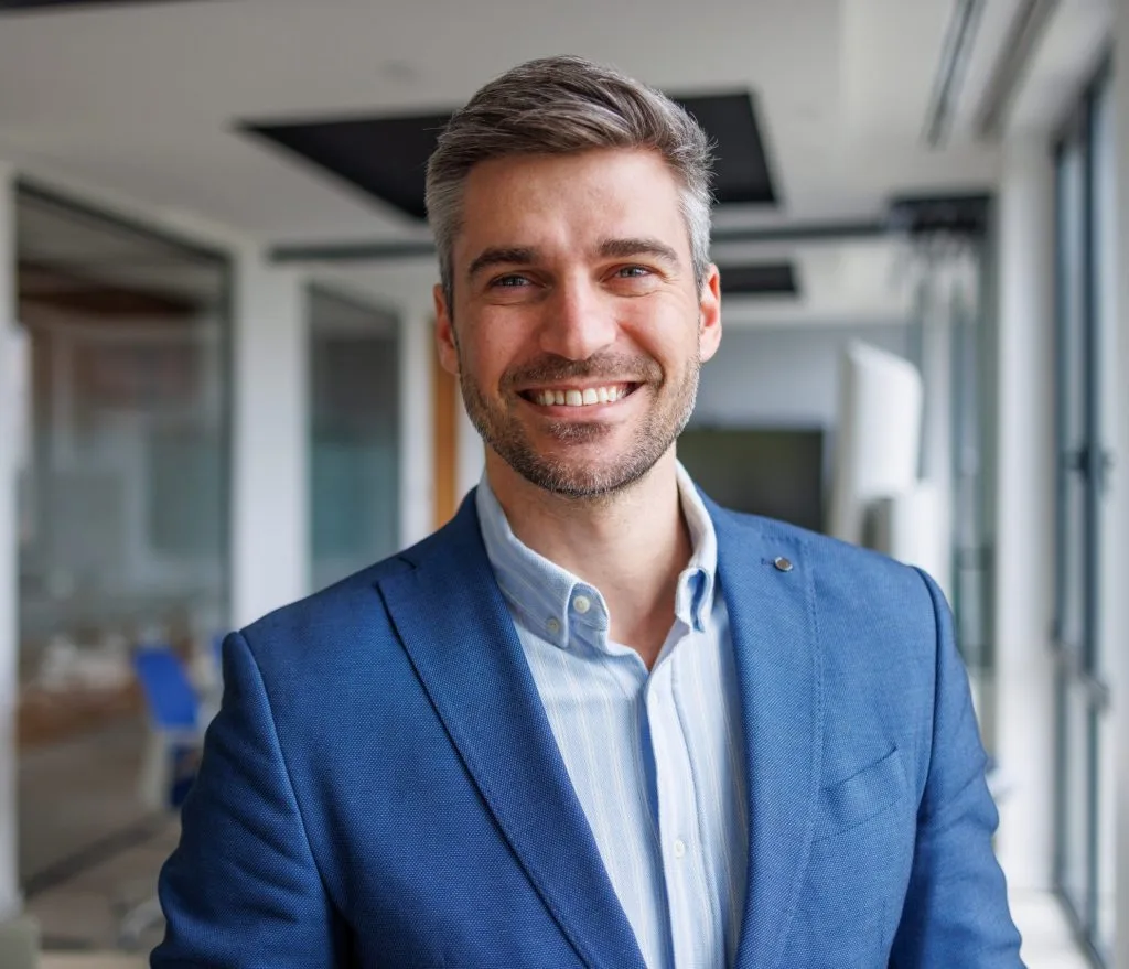 Smiling man in a blue blazer