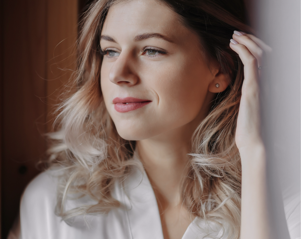 Woman with healthy, voluminous hair touching her head