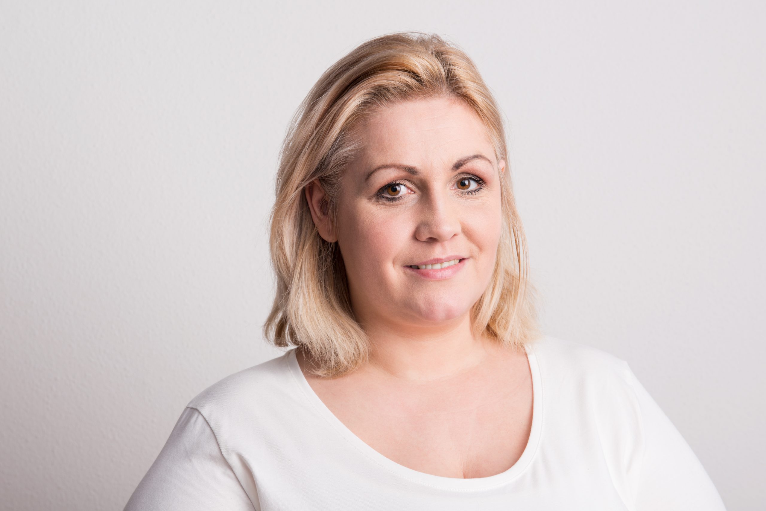 Woman smiling at camera in studio portrait