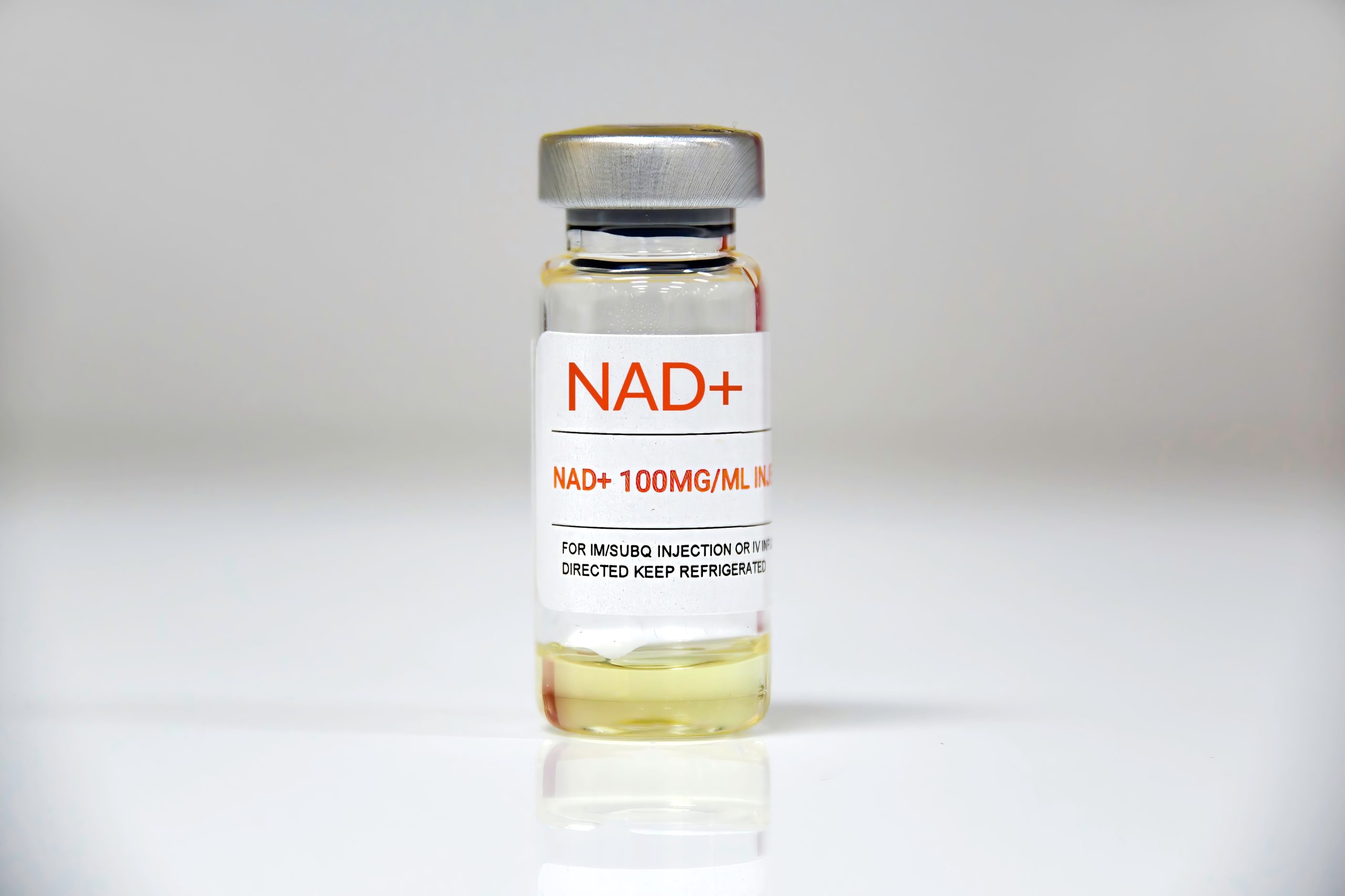 NAD+ 100MG/ML vial for intramuscular injection on white background