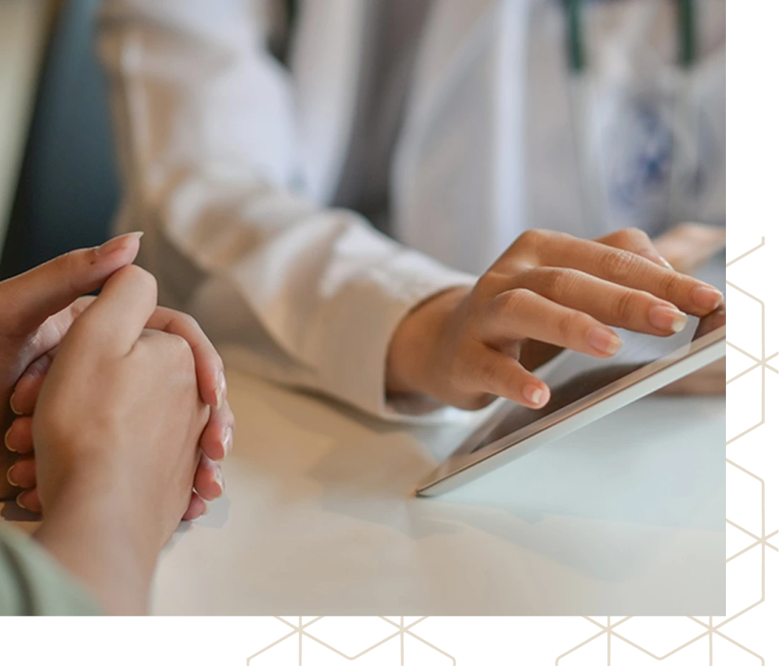 Healthcare provider and patient reviewing information on tablet together