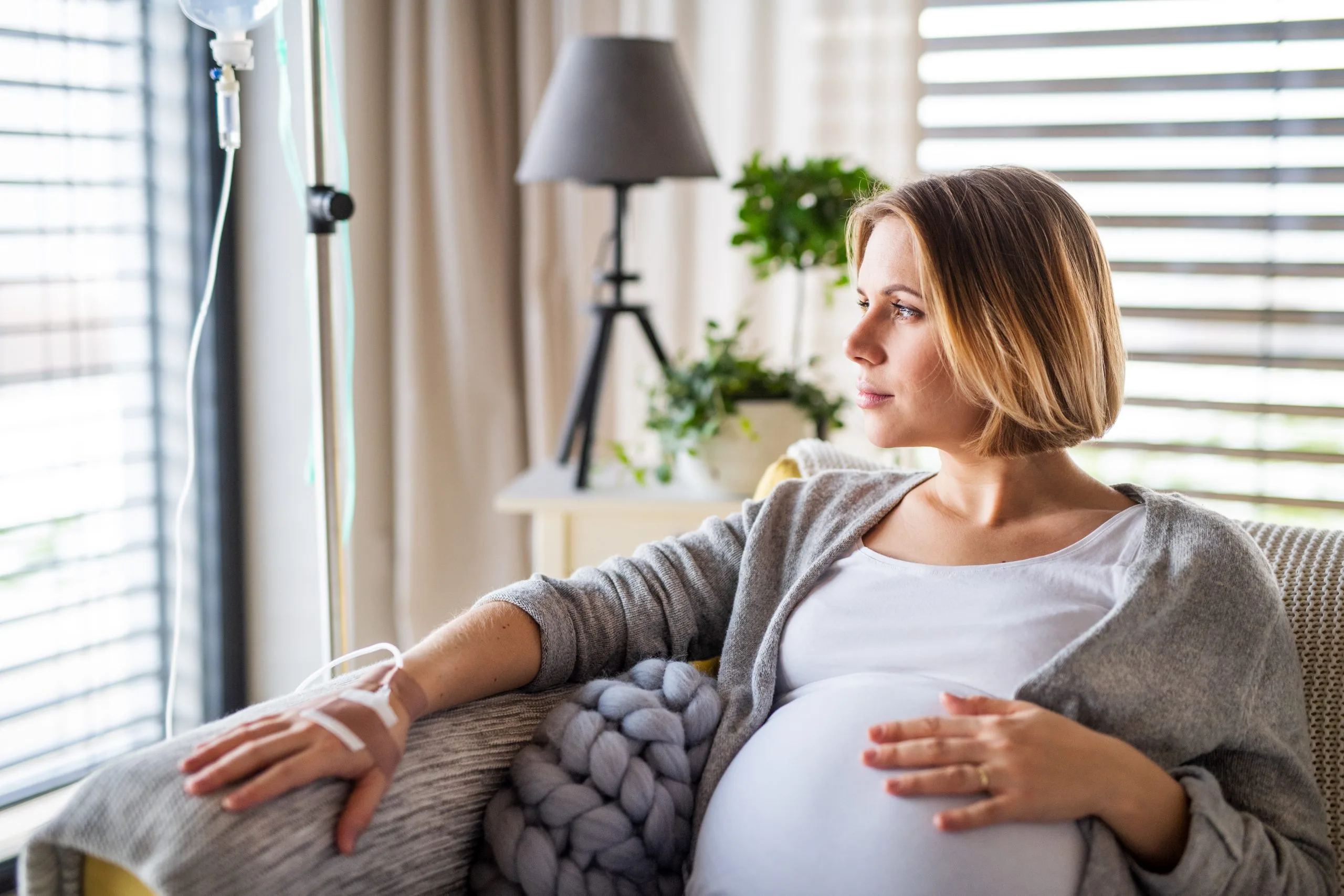 Pregnant woman receiving intravenous infusion therapy at home