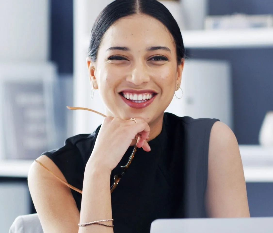 Smiling woman at a desk – medication management patient in Bala Cynwyd, PA