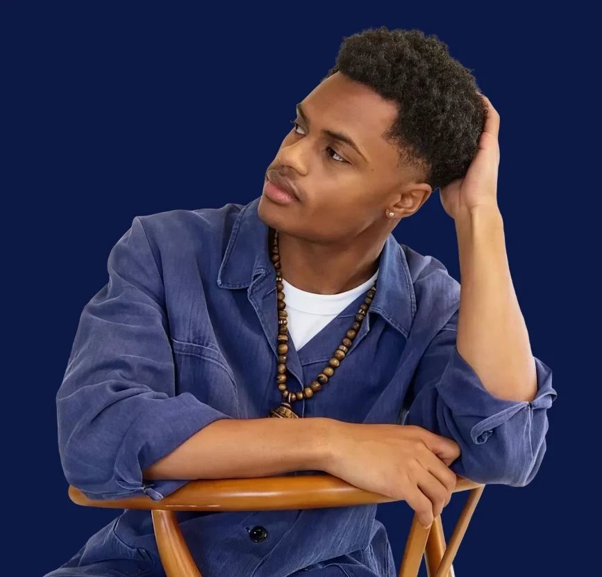 Young man seated in a chair, looking thoughtfully to the side – physician-only psychiatric care