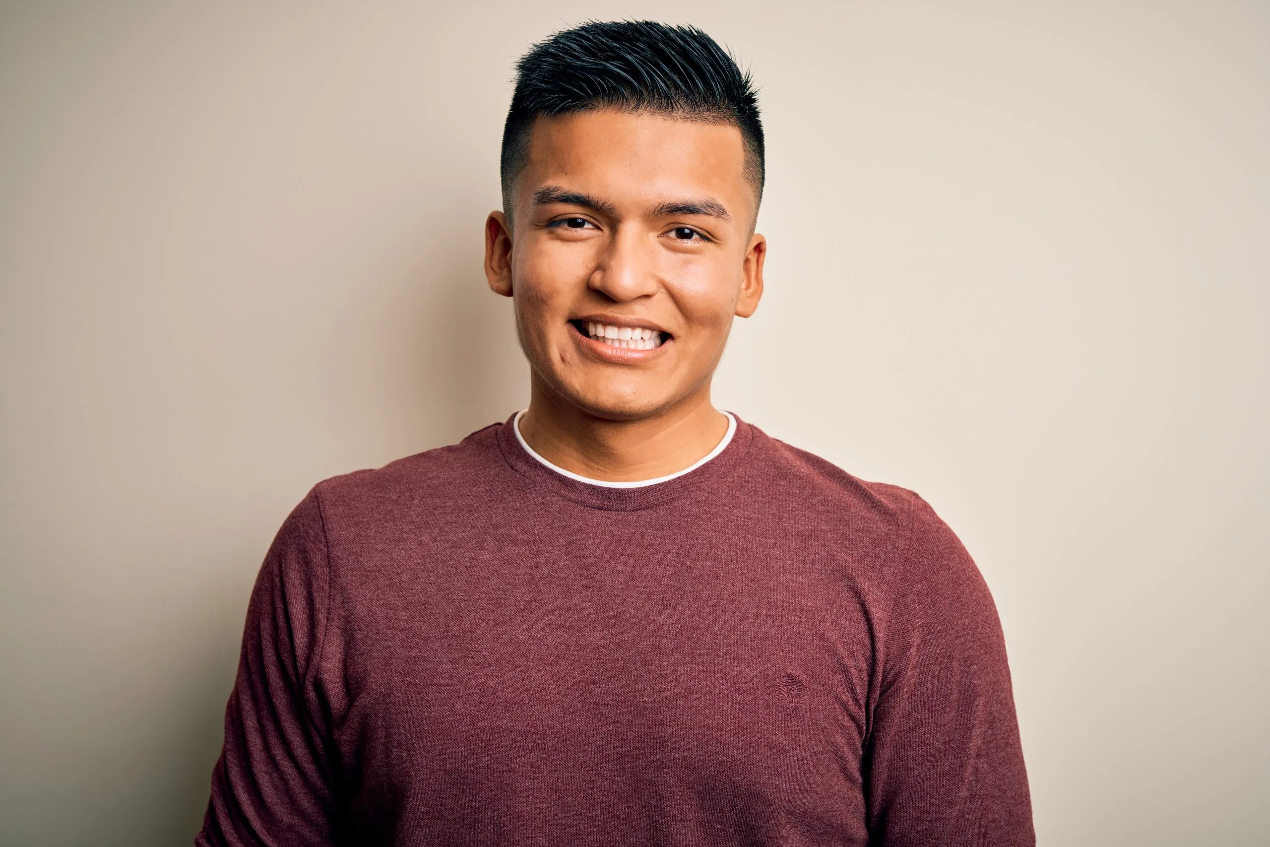 Man smiling at the camera in a casual portrait