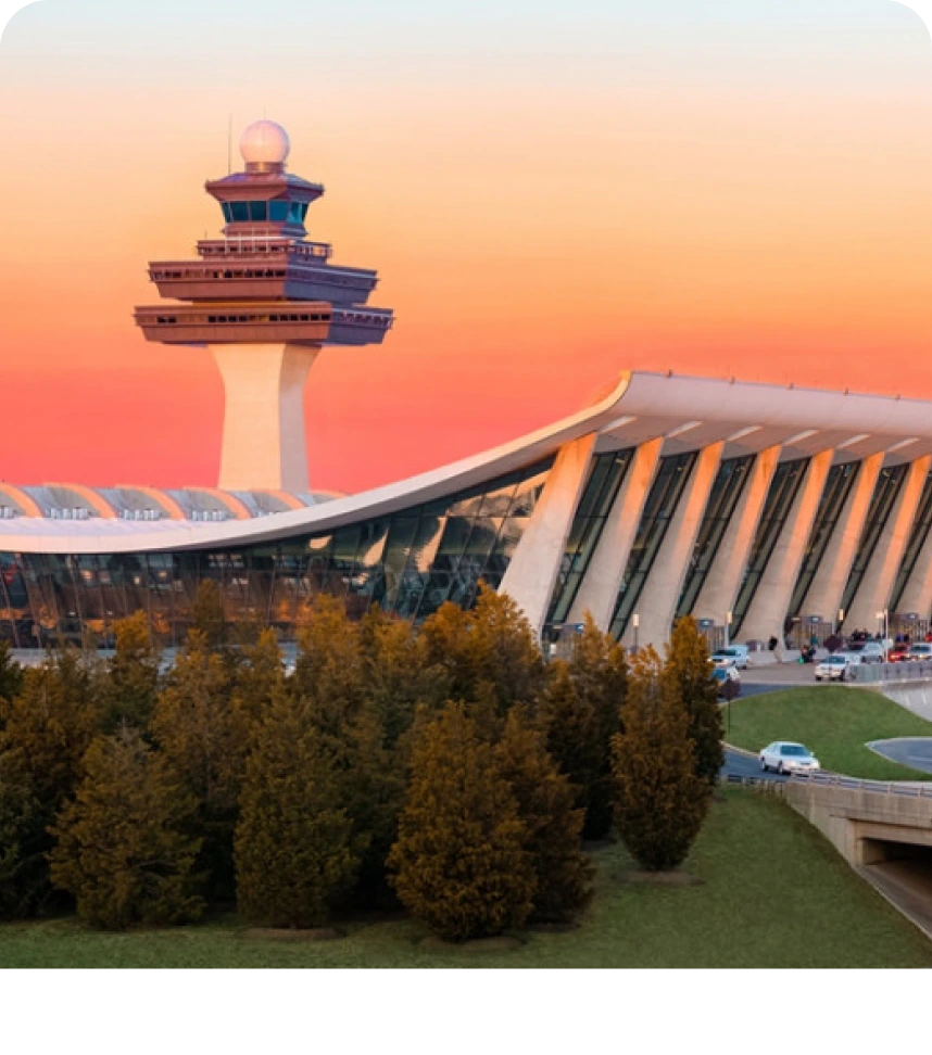 Modern airport terminal with control tower at sunset